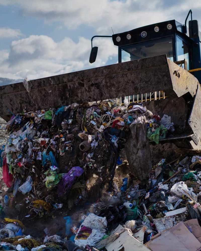 garbage-truck-unloading-waste-on-landfill-environ-XKK37ZM.jpg